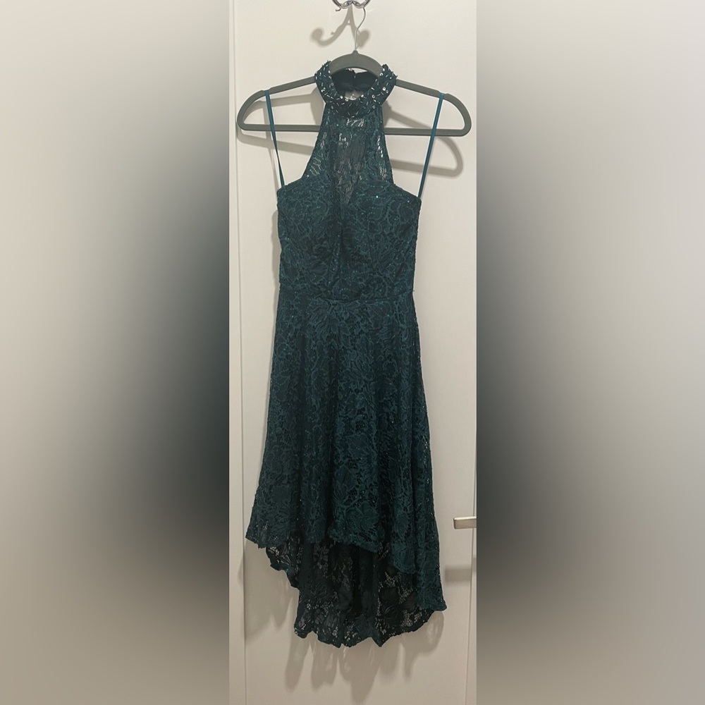 A high-low gorgeous dark green lace dress with sequins for the perfect look!